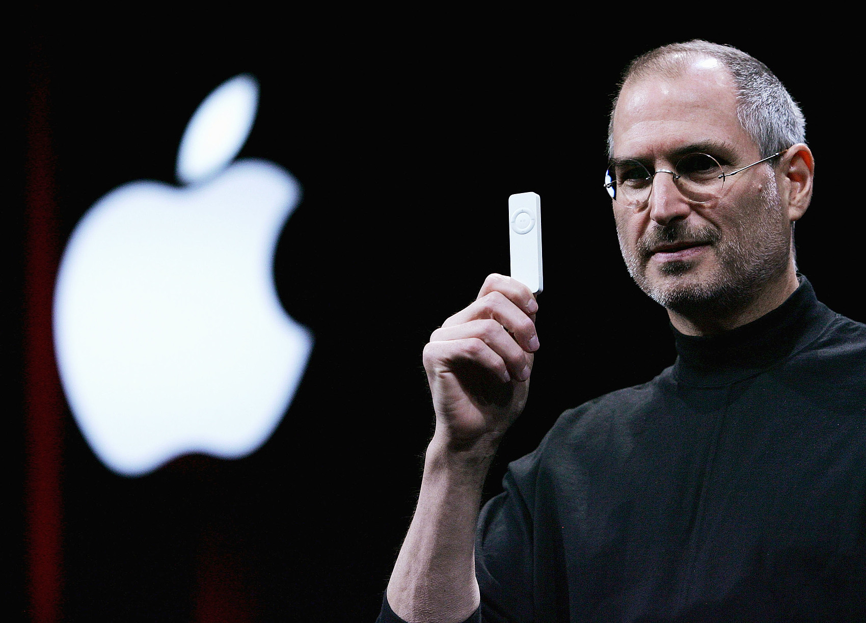 Steve Jobs holds a new iPod shuffle at the Macworld Expo, January 11, 2005